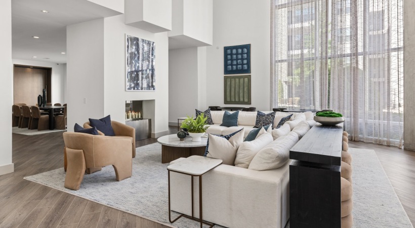 a clubroom with a couch, tables and chairs